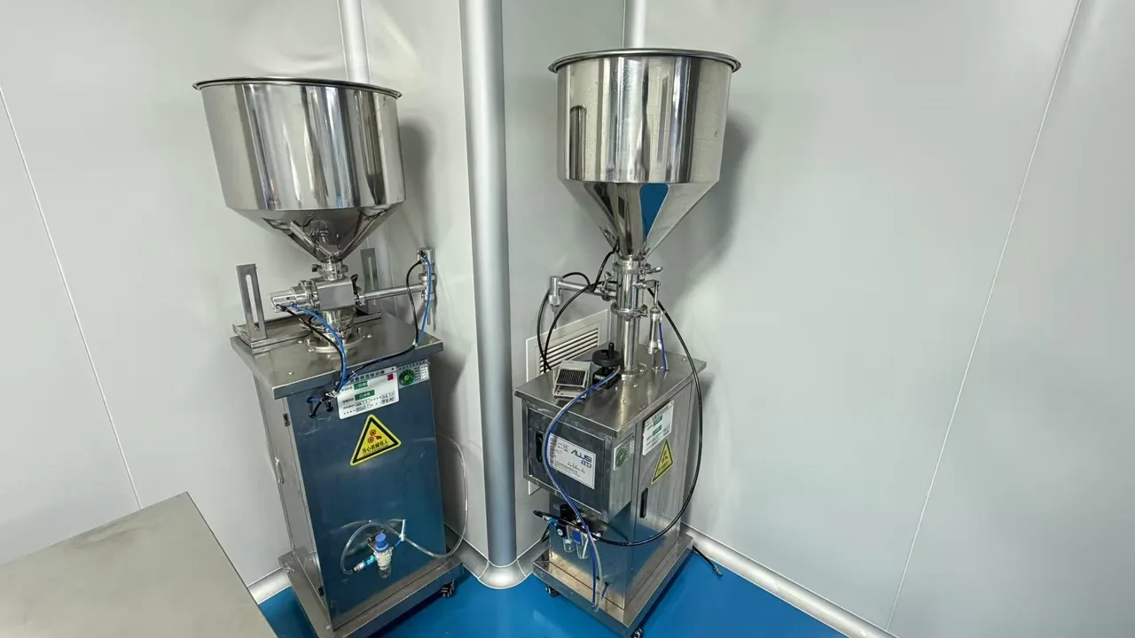 Two filling machines with stainless steel hoppers